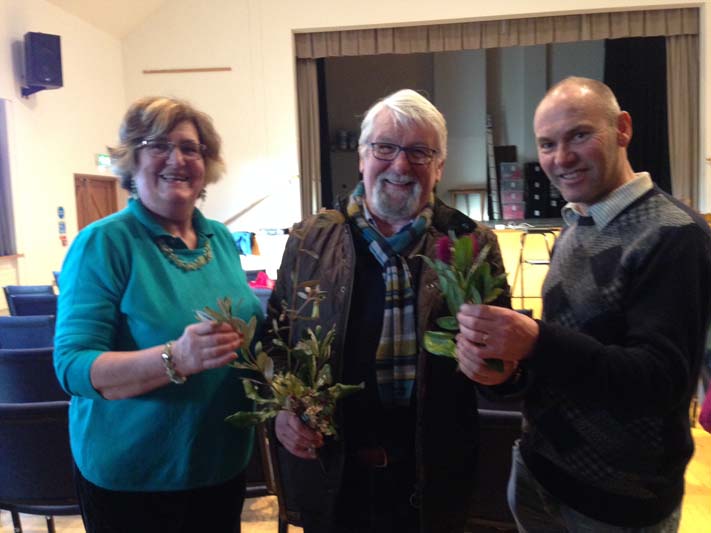 Marion Allen and Victor Henry admiring some of the foliage from Logan brought by the speaker, Richard Baines. 