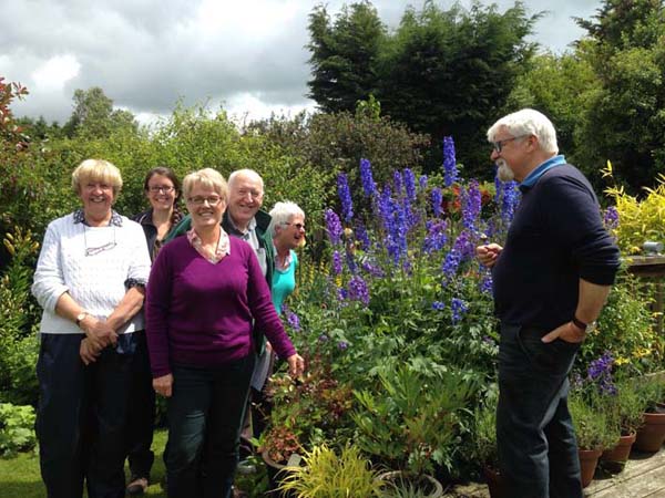 Victor Henry greeting the visitors as all admire the wonderful delphiniums