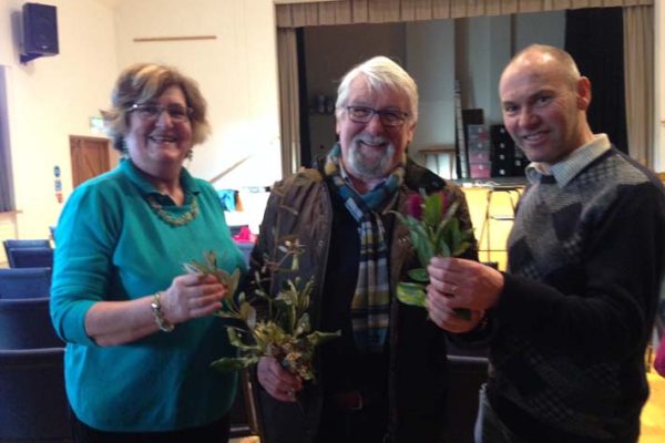 Marion Allen and Victor Henry admiring some of the foliage from Logan brought by the speaker, Richard Baines.